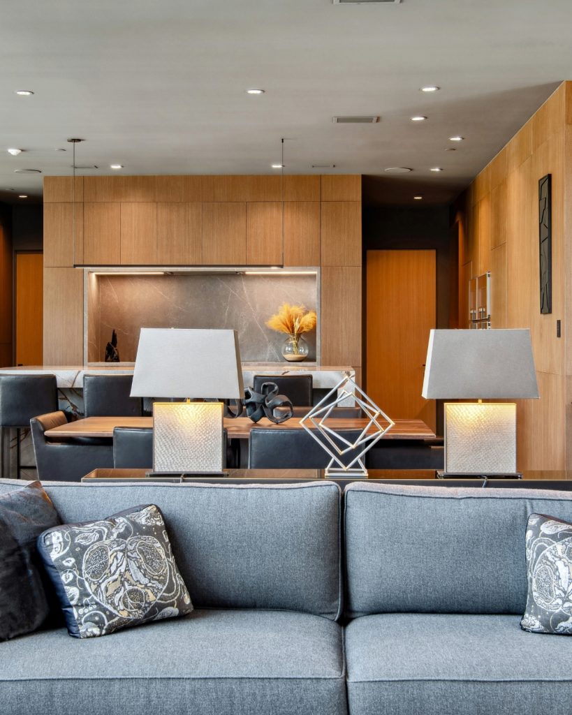 Bedroom styled like a luxury hotel with crisp white bedding, plush pillows, and warm ambient lighting