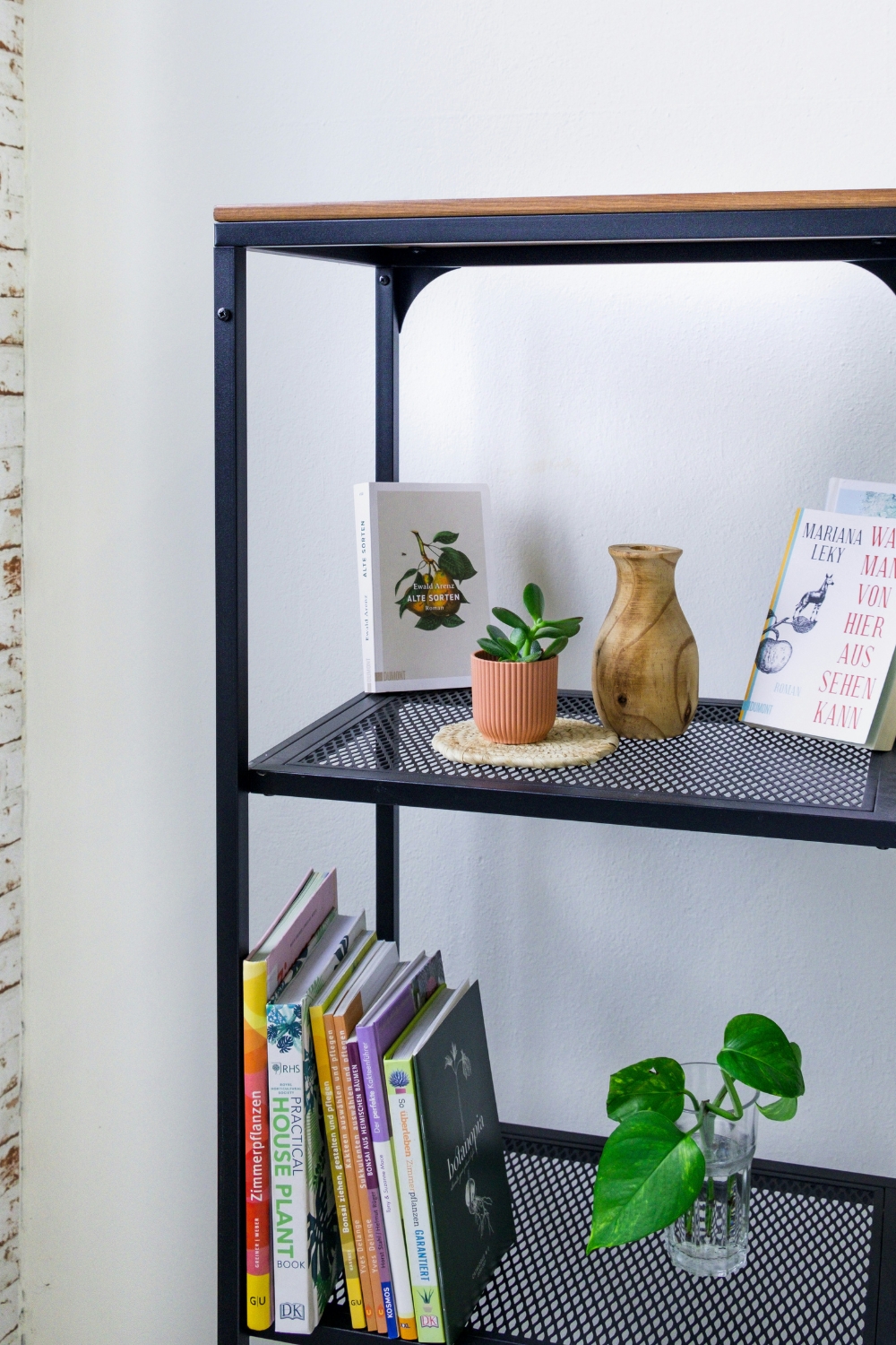 Floating shelves displaying framed artwork and small sculptures in a modern living room