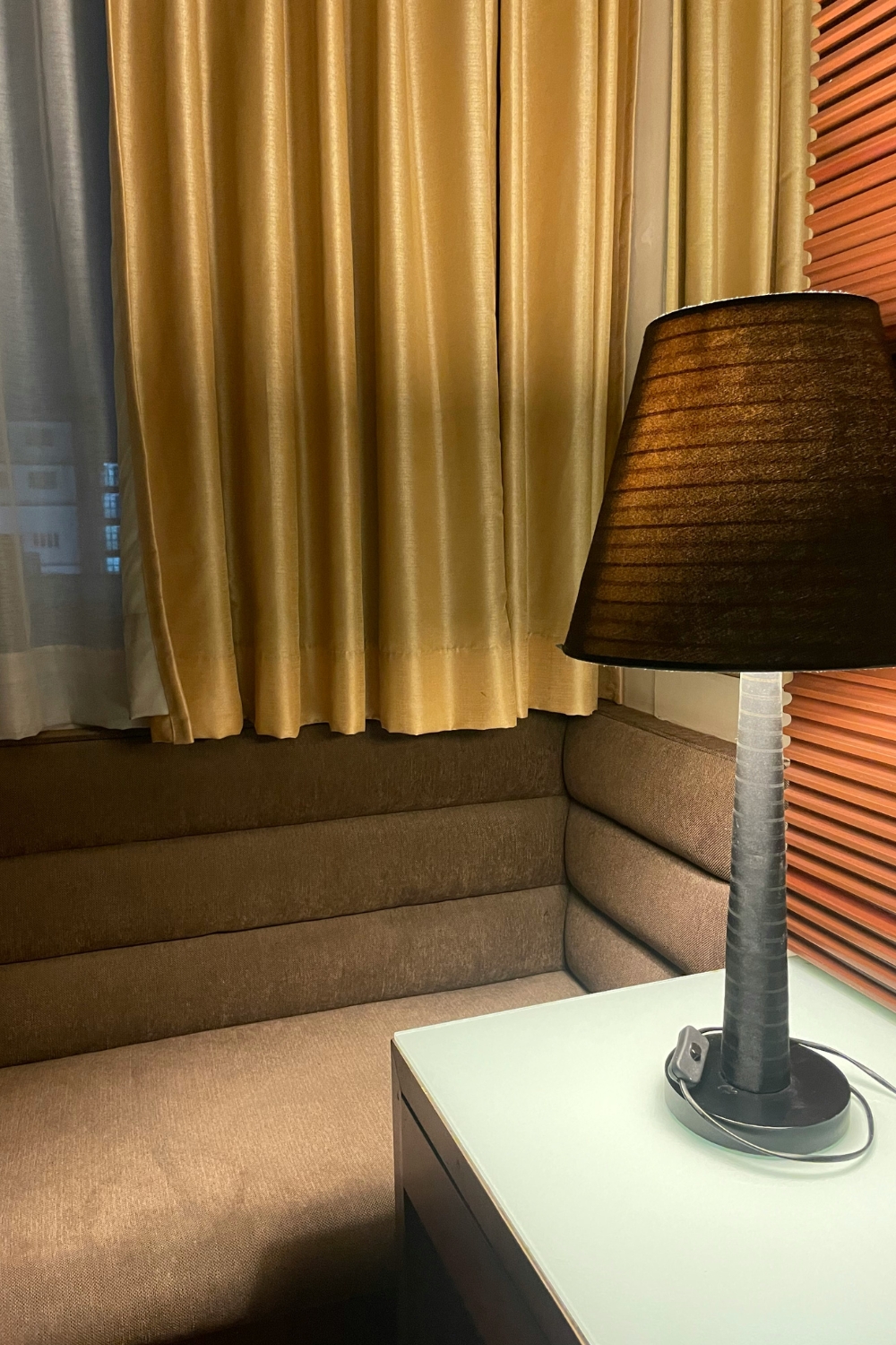 Hotel-inspired bedroom with layered textures including soft duvet, velvet pillows, and a cozy throw