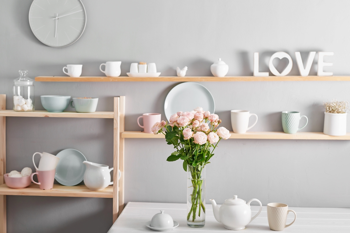 Kitchen shelves styled with ceramics, cookbooks and art prints