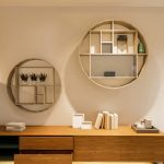 Floating shelves styled with decor and storage in a modern living room