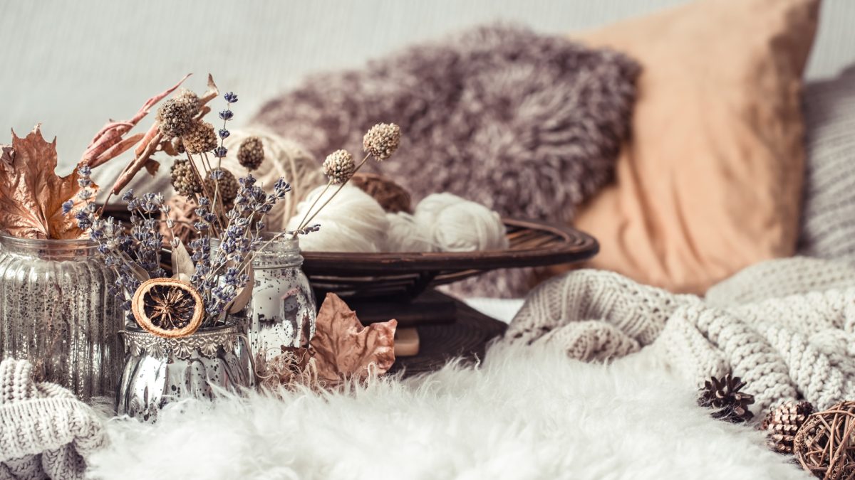 Living room styled with cozy rustic autumn decor and warm textures