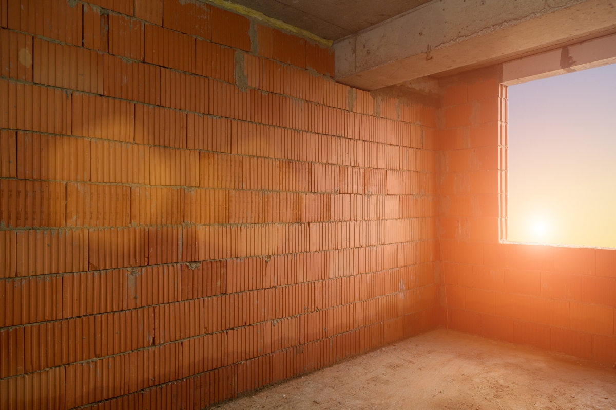 Living room wall with textured plaster base layer for layered wall design