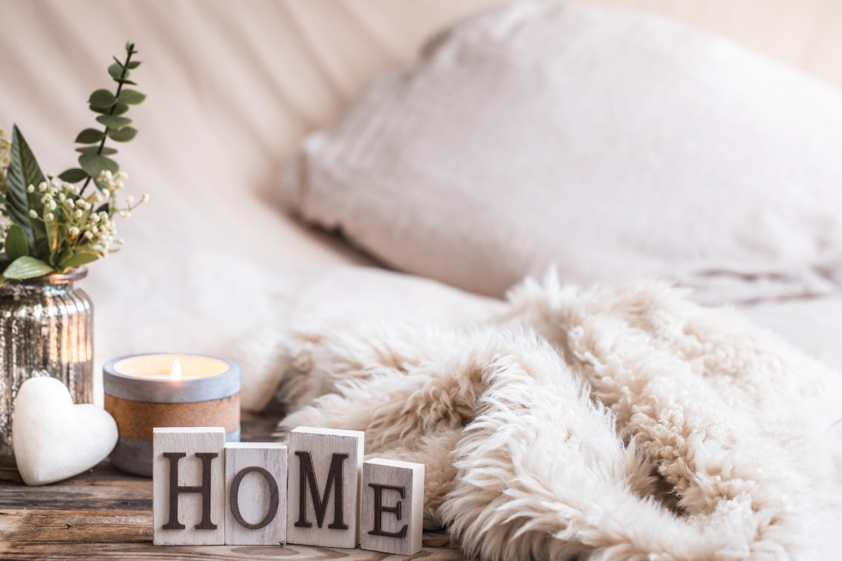 Autumn-inspired bedroom with warm bedding, layered throws, and pillows