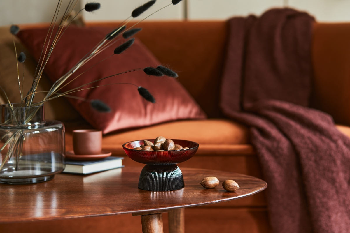 Living room featuring earthy and warm fall color palette with terracotta and clay tones