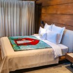 Boutique hotel-inspired bedroom with layered bedding and neutral tones