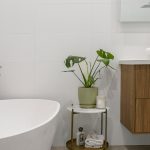Modern bathroom with stone countertops and wood-look vanity for a stylish finish