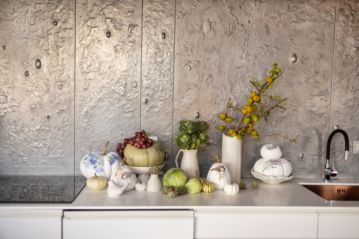 Homeowner planning kitchen wall layout for decor and storage