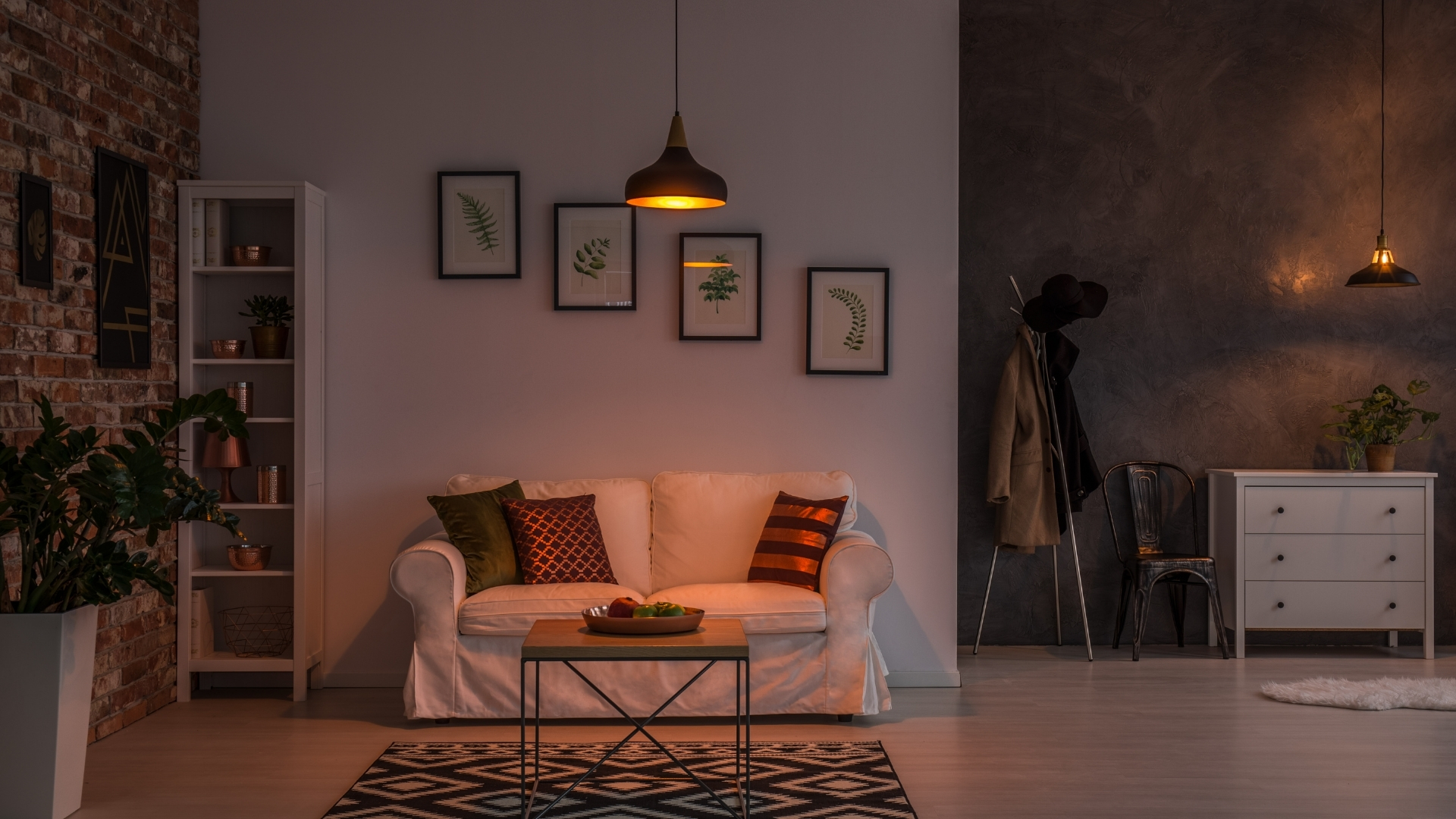 Living room with layered winter lighting including lamps, candles, and string lights