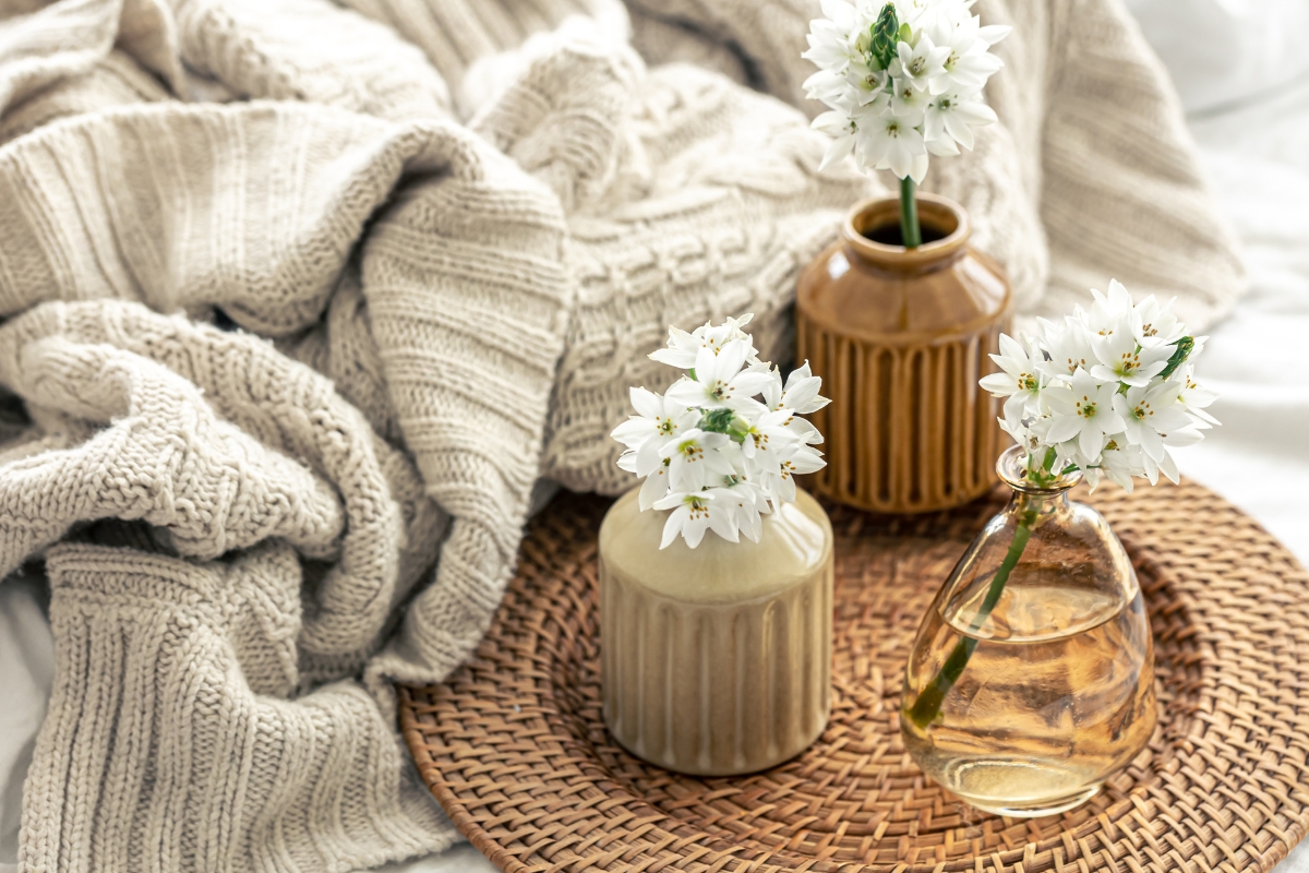 Living room styled with linen throws, woven baskets, and light wood furniture for spring