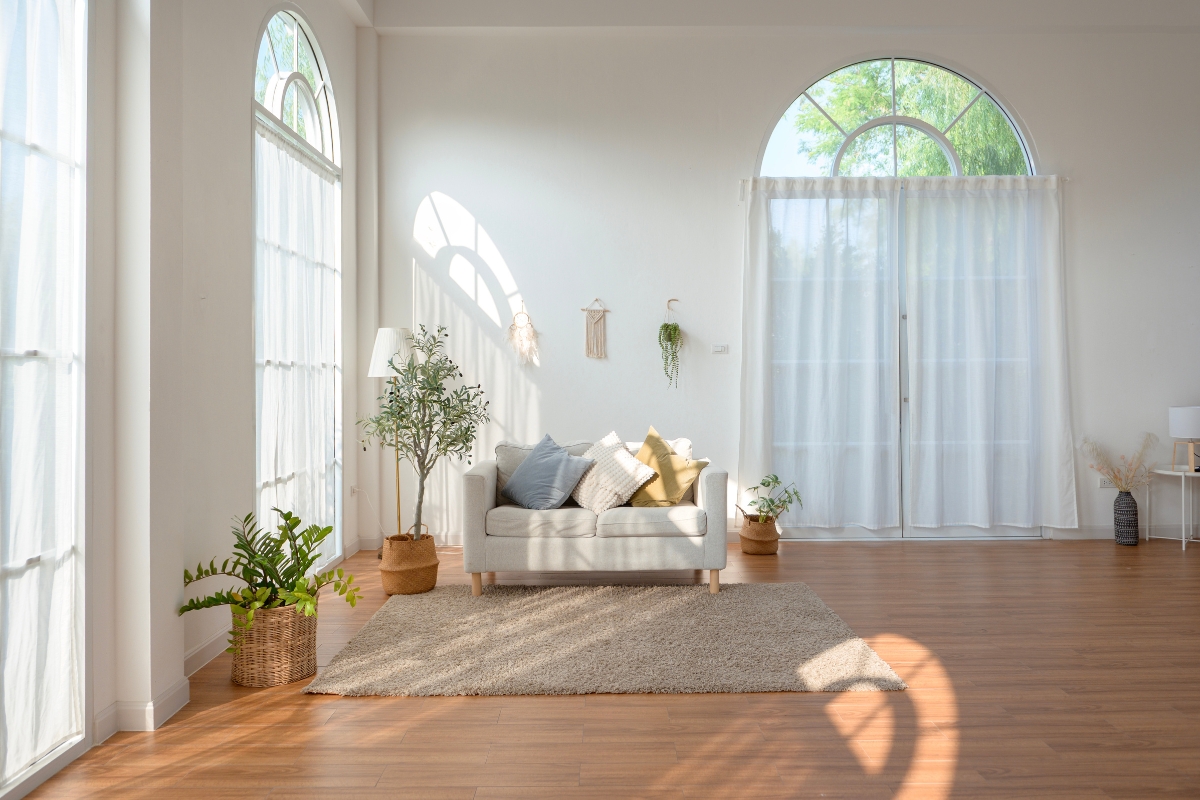 Living room with sheer curtains allowing natural sunlight to brighten the space