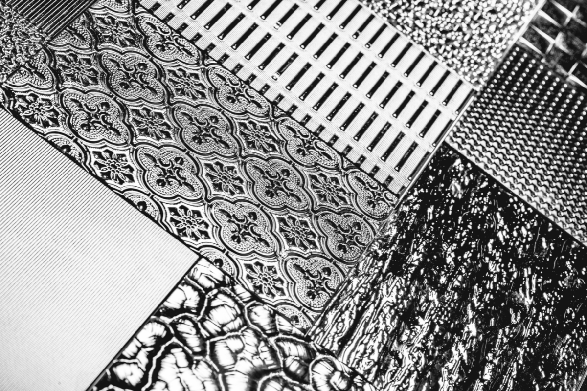 Living room sofa layered with boucle, velvet, and knit throw pillows for mixed textures