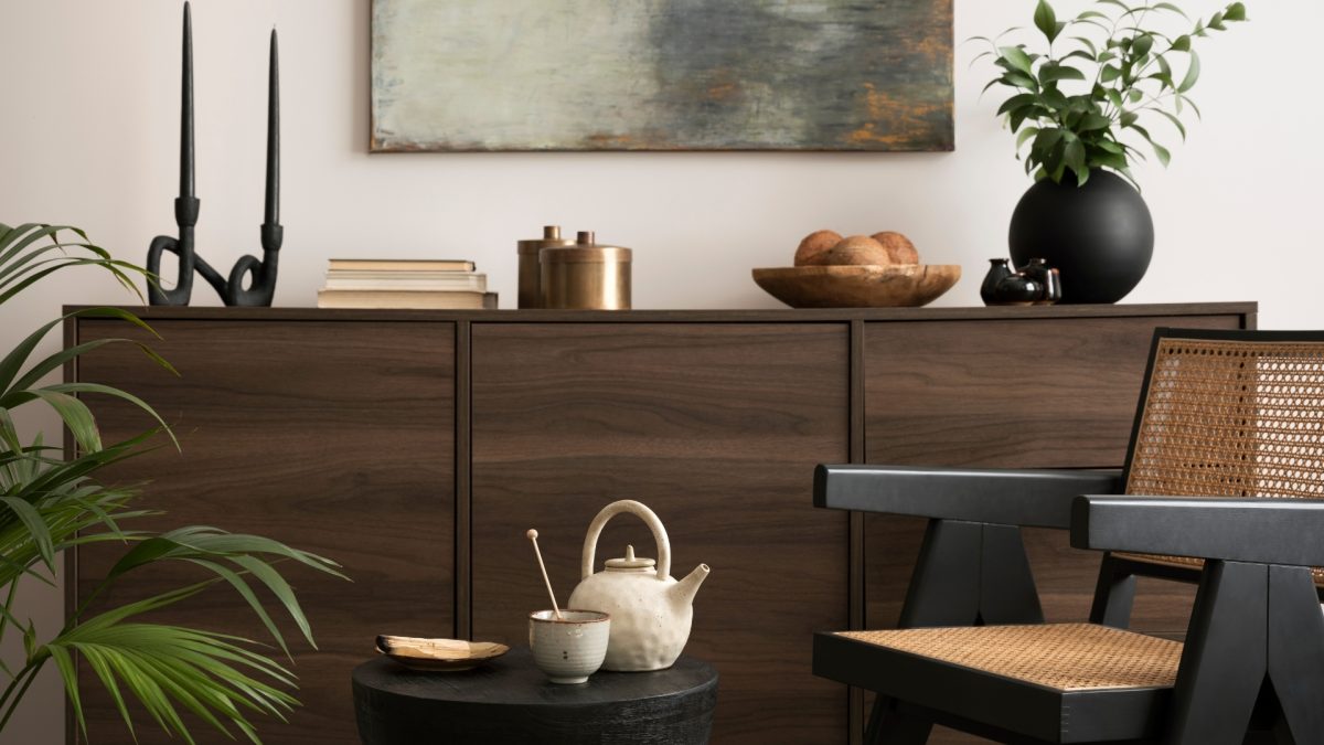 Modern living room showcasing mixed materials with a wooden coffee table, metal-framed sofa, and fabric cushions layered for texture and style