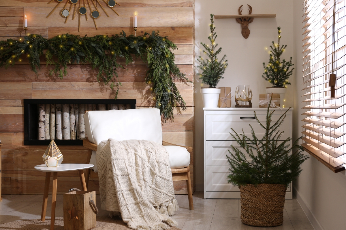Living room decorated with natural evergreen branches, eucalyptus, and cedar for a long-lasting winter greenery look.