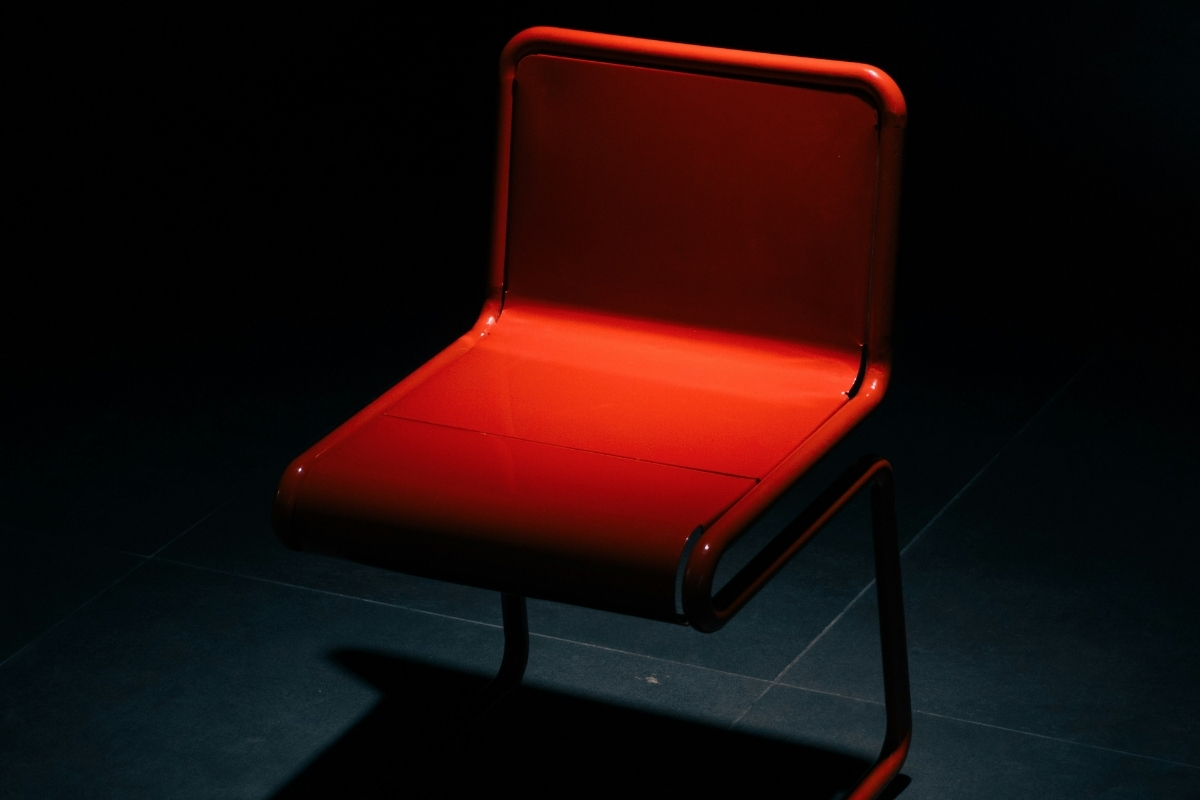 Living room with a gray fabric sofa, warm wooden coffee table, and black metal accents, demonstrating balanced color and contrast for a stylish, layered look