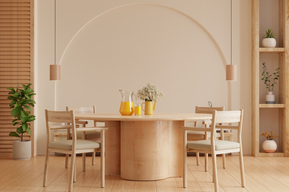 Round wood dining table in modern dining room with upholstered chairs 2026 furniture trend