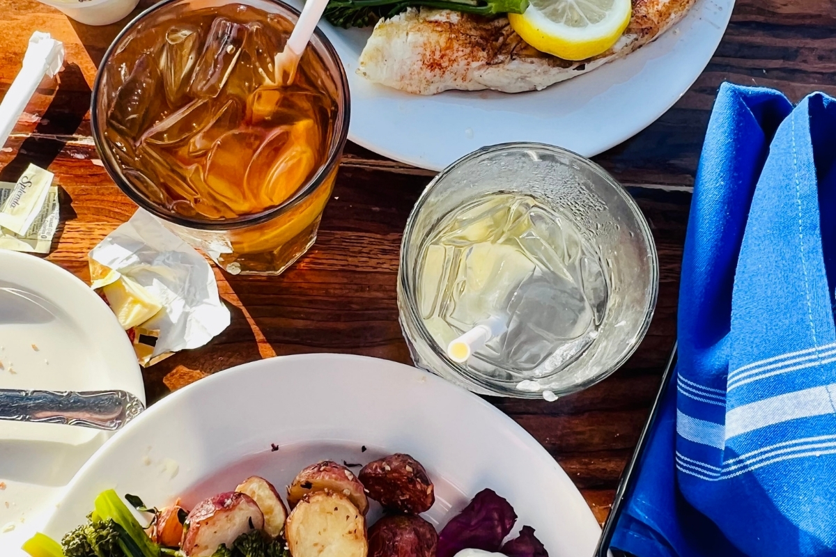 Dining table styled with autumn colors, pumpkins, and cozy accents