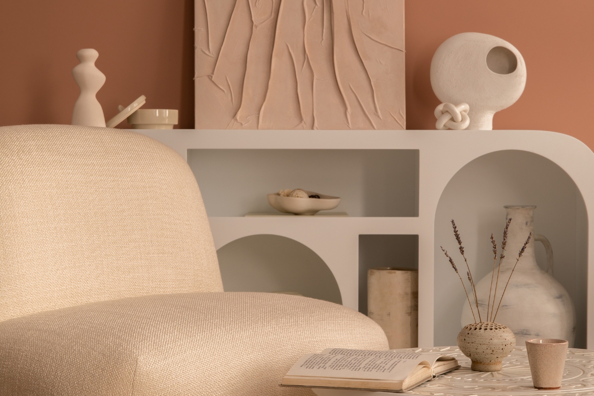 Curved modern sofa with soft edges styled in a cozy living room for 2026 decor trends