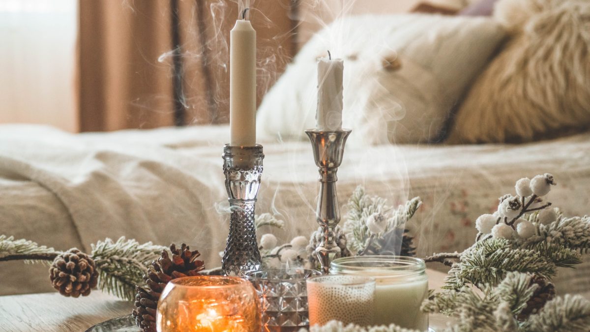 Cozy winter living room with layered blankets, warm lighting, and rustic wooden accents, perfect for cold days.