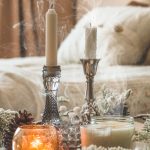 Cozy winter living room with layered blankets, warm lighting, and rustic wooden accents, perfect for cold days.