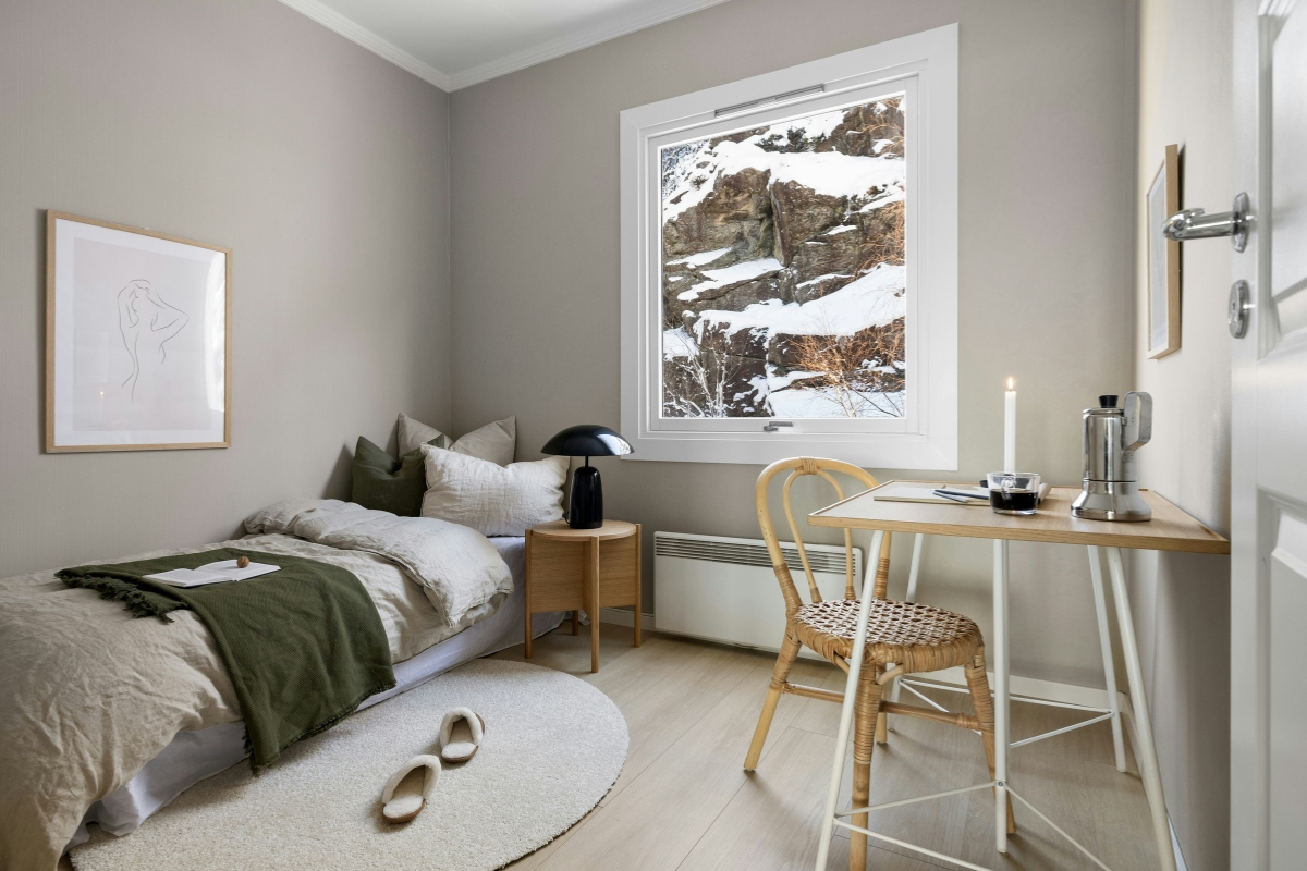 Winter living room styled with natural elements like wooden accents, bare branches, and greenery creating a calm, cozy, and elegant atmosphere after the holidays.