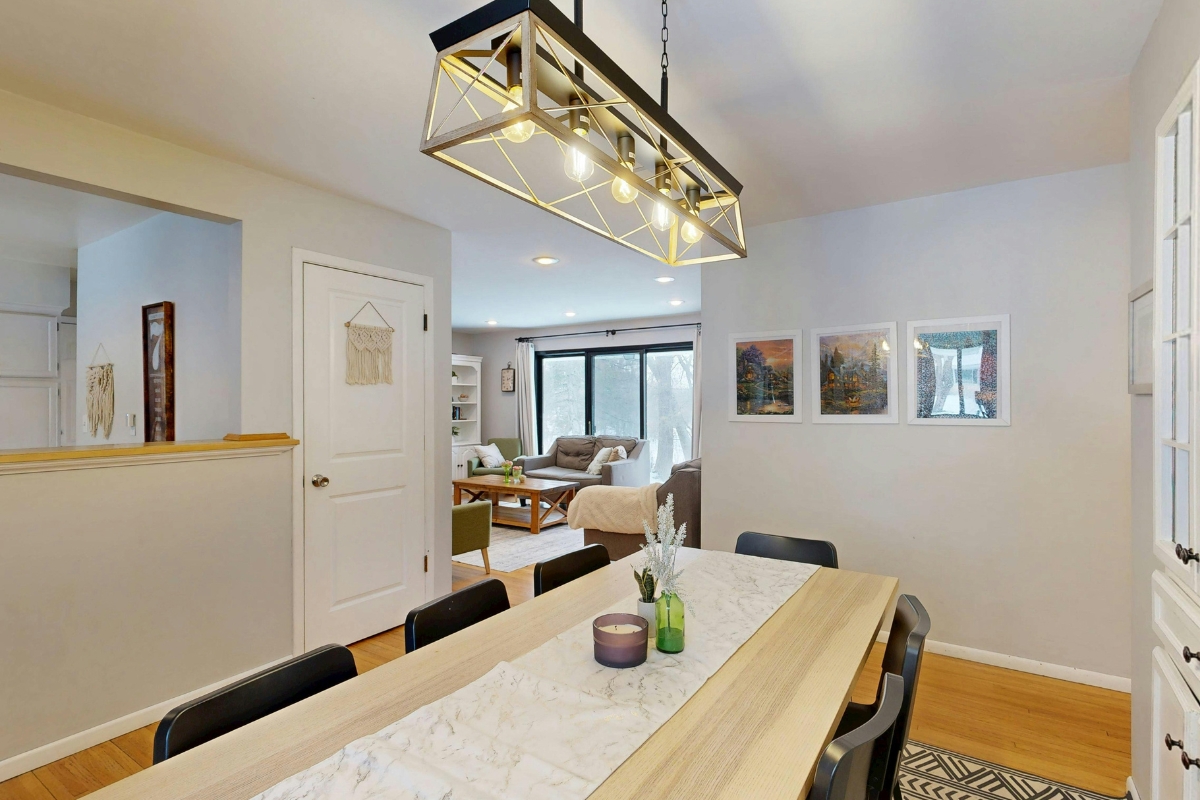 Open-concept dining room decorated with minimal decor and personal accents