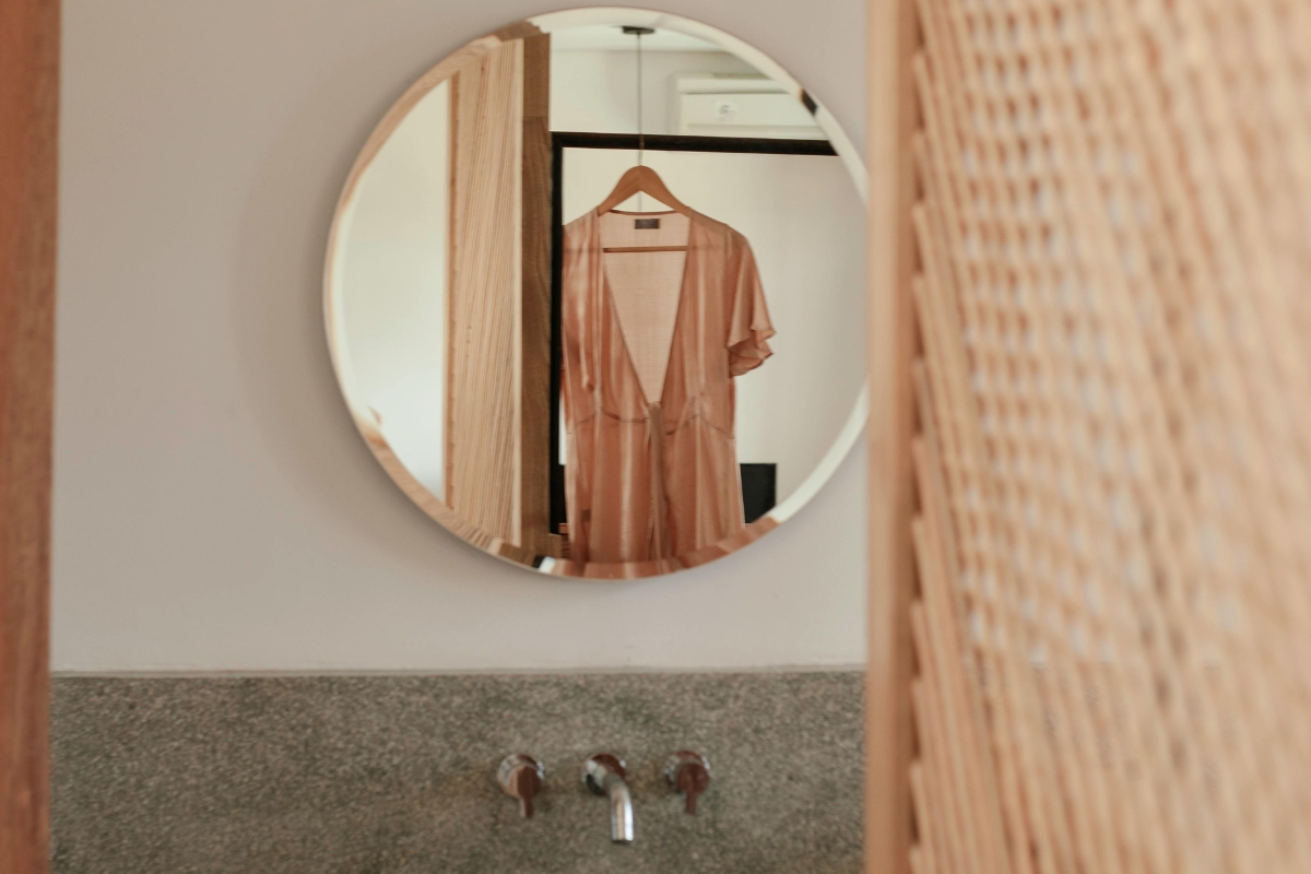 Earth-toned bathroom styled with textured towels and linen shower curtain