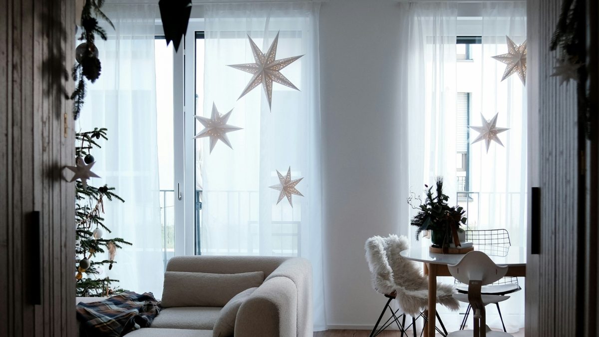 Cozy living room styled for winter with neutral tones, soft blankets, warm lighting, and simple decor after holiday decorations are removed.