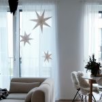 Cozy living room styled for winter with neutral tones, soft blankets, warm lighting, and simple decor after holiday decorations are removed.