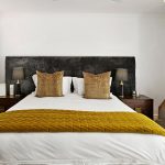 Cozy bedroom styling ideas with layered bedding and warm lighting