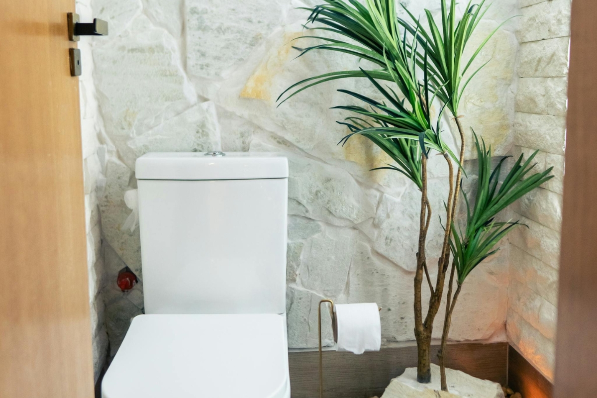 Earth-toned bathroom with indoor plants and natural wood accents