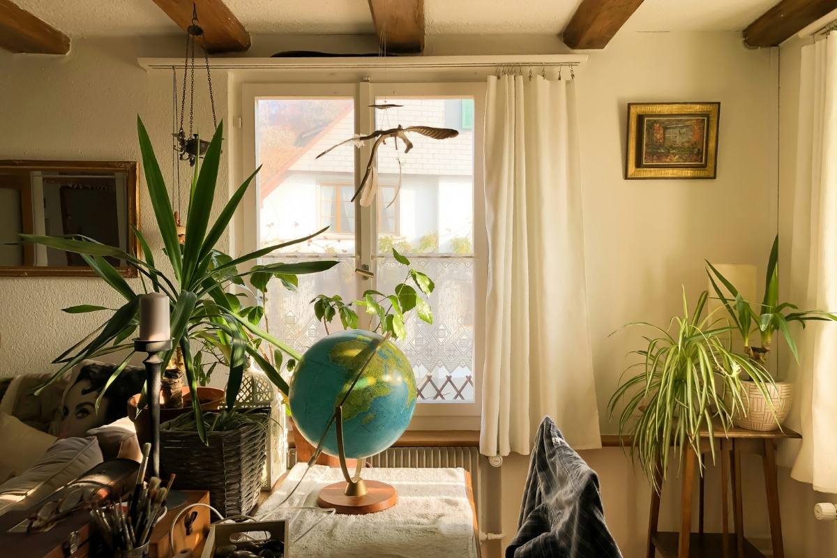 Bright, airy living room with minimal furniture, clean surfaces, soft natural light, and organized decor creating a fresh and clutter-free spring home atmosphere.