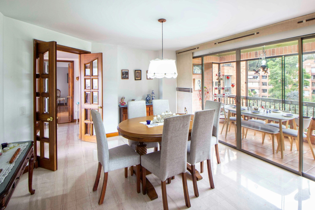 Open-concept dining area defined without walls using rug and pendant lighting