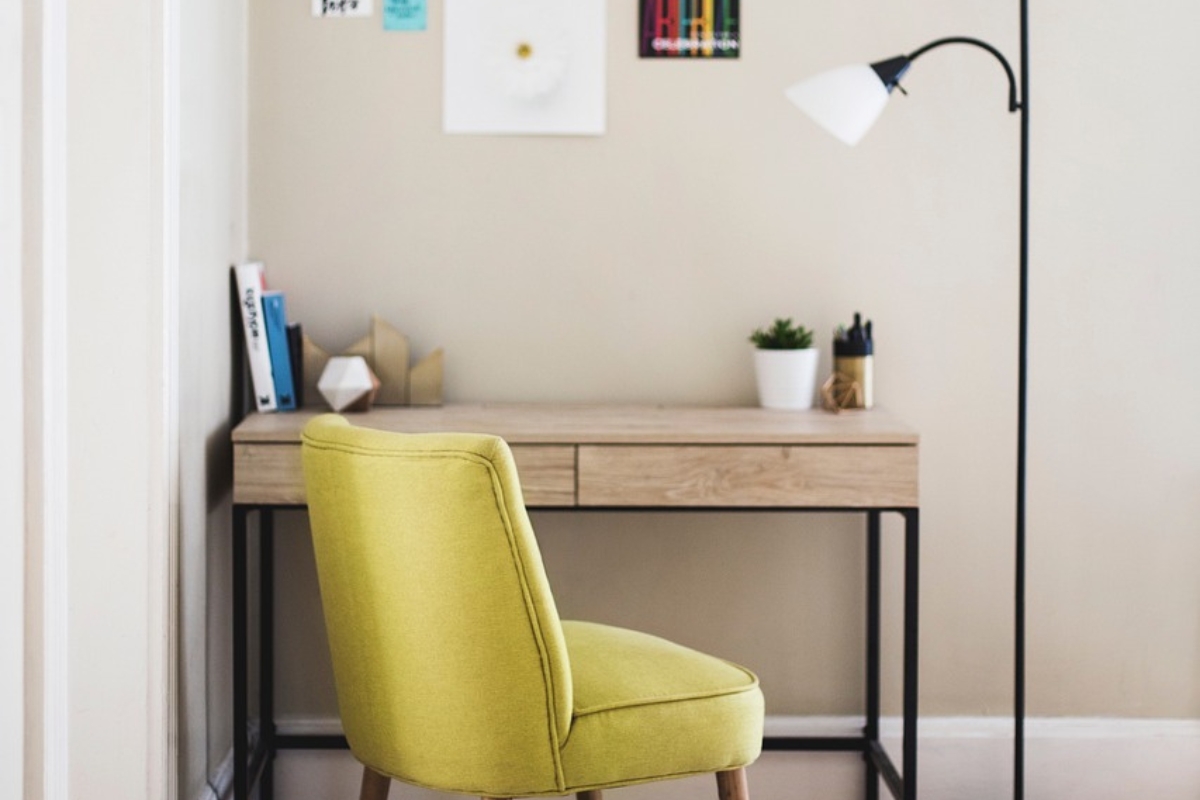 Montessori-inspired kids room with defined creative corners including reading nook, art station, and floor mat for independent play and learning