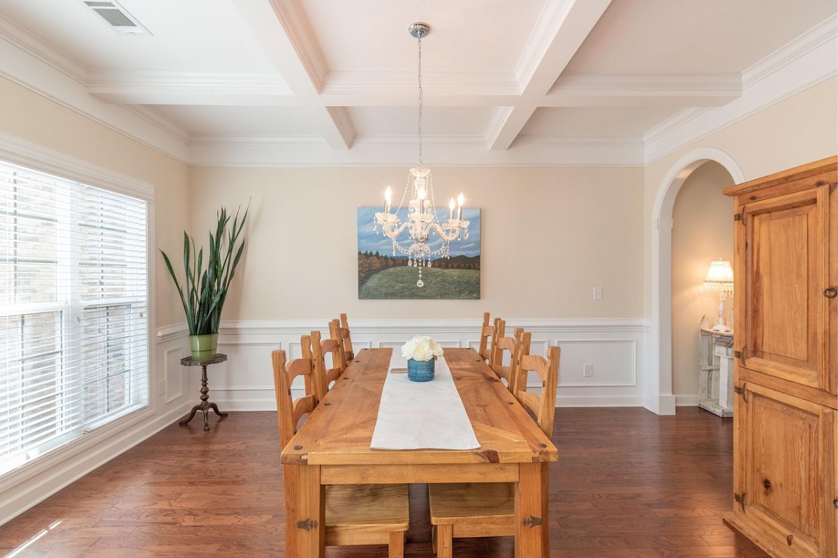 Modern chandelier dining room light fixture above wooden table