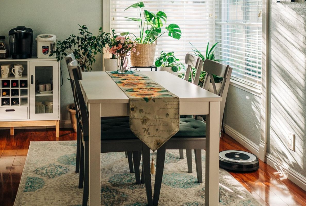 Large dining room rug under wooden dining table