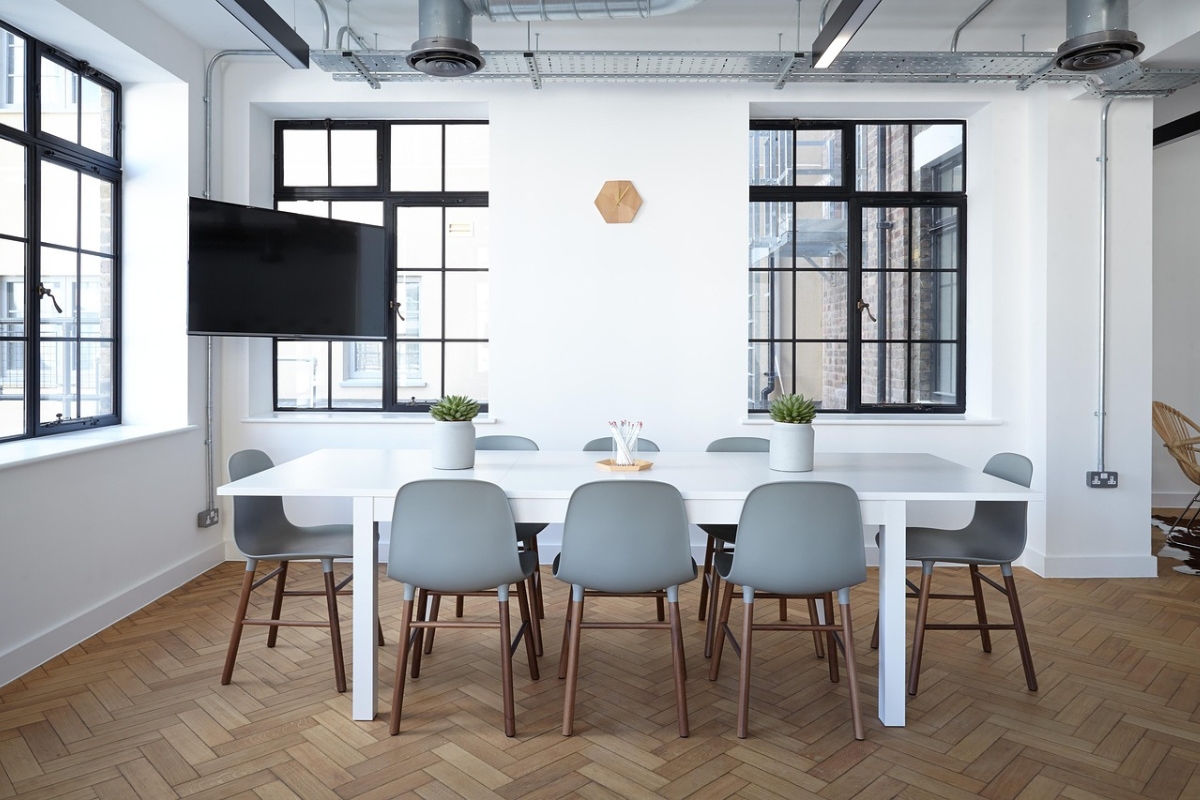 Spacious dining room featuring two matching pendant lights above a long wooden table, creating balanced and modern ambiance.