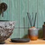 Earth-toned bathroom with natural wood vanity and warm neutral tiles