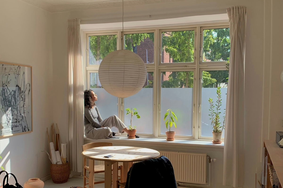 Decluttering living room before summer decoratingMinimal furniture layout creating an airy home space