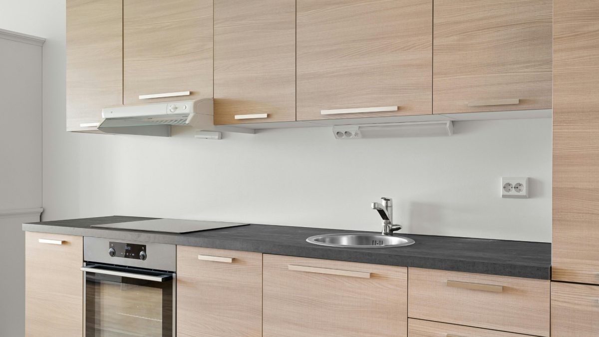 Functional kitchen wall decor with floating shelves, hanging hooks, and organized display creating a stylish and practical modern kitchen space
