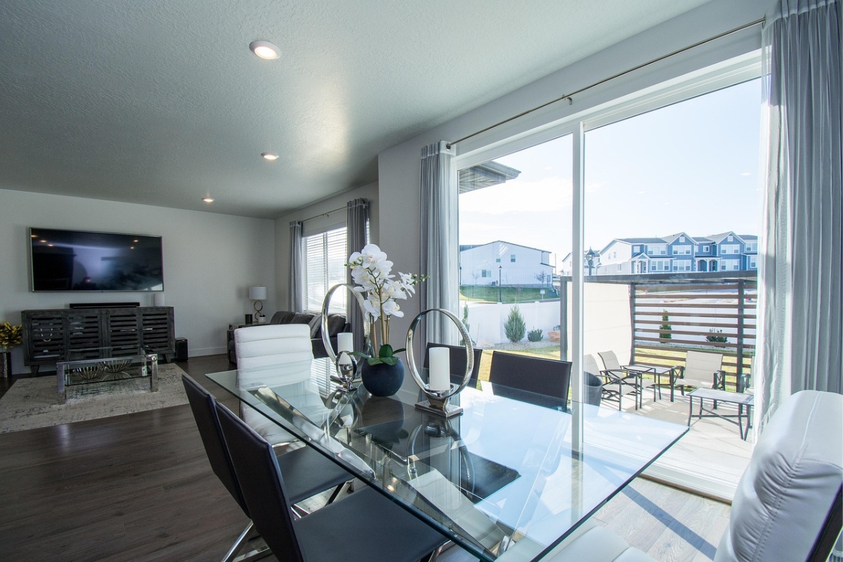 modern glass panel living room divider separating seating and dining area while allowing natural light