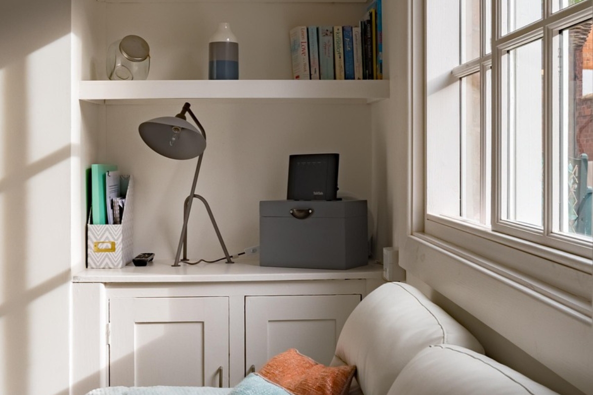 low half wall used as a living room divider separating seating area from dining space in modern open plan home
