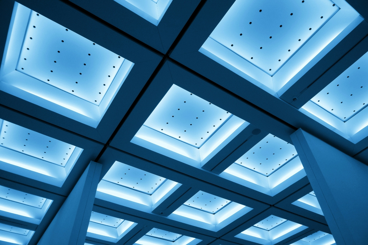 Layered ceiling design with panels and hidden lighting in modern living room