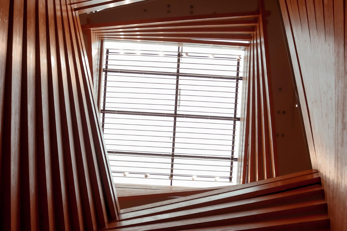 Bedroom with vertical striped wallpaper creating the illusion of a taller ceiling