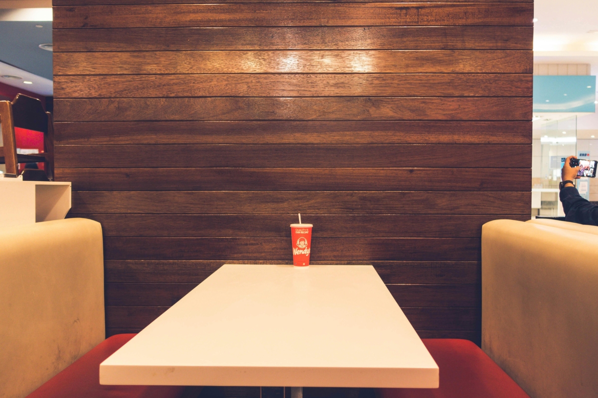 Dining room styled with soft textures including cushions, rugs, and table linens