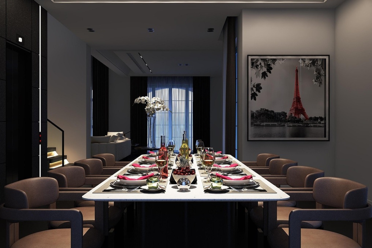 Modern dining room with long rectangular table illuminated by sleek linear chandelier, creating balanced and stylish ambiance.