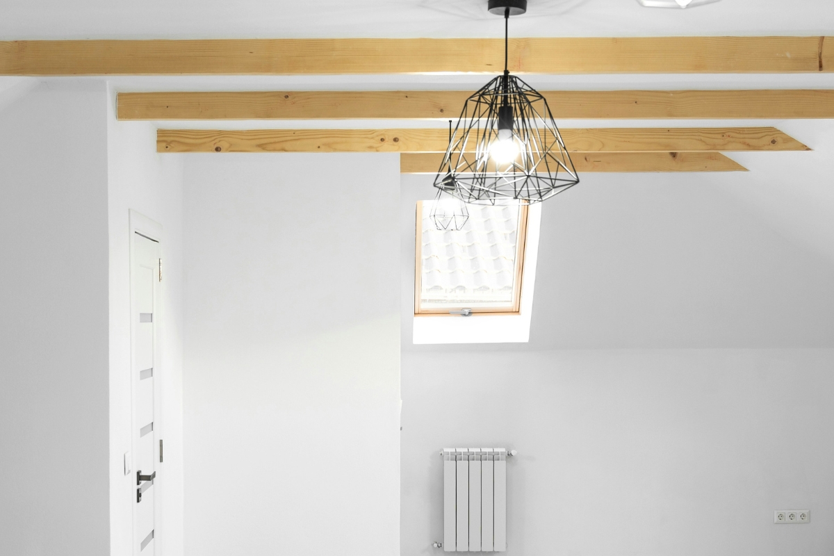 Living room with low ceiling painted white, vertical accents, and mirrors to feel taller