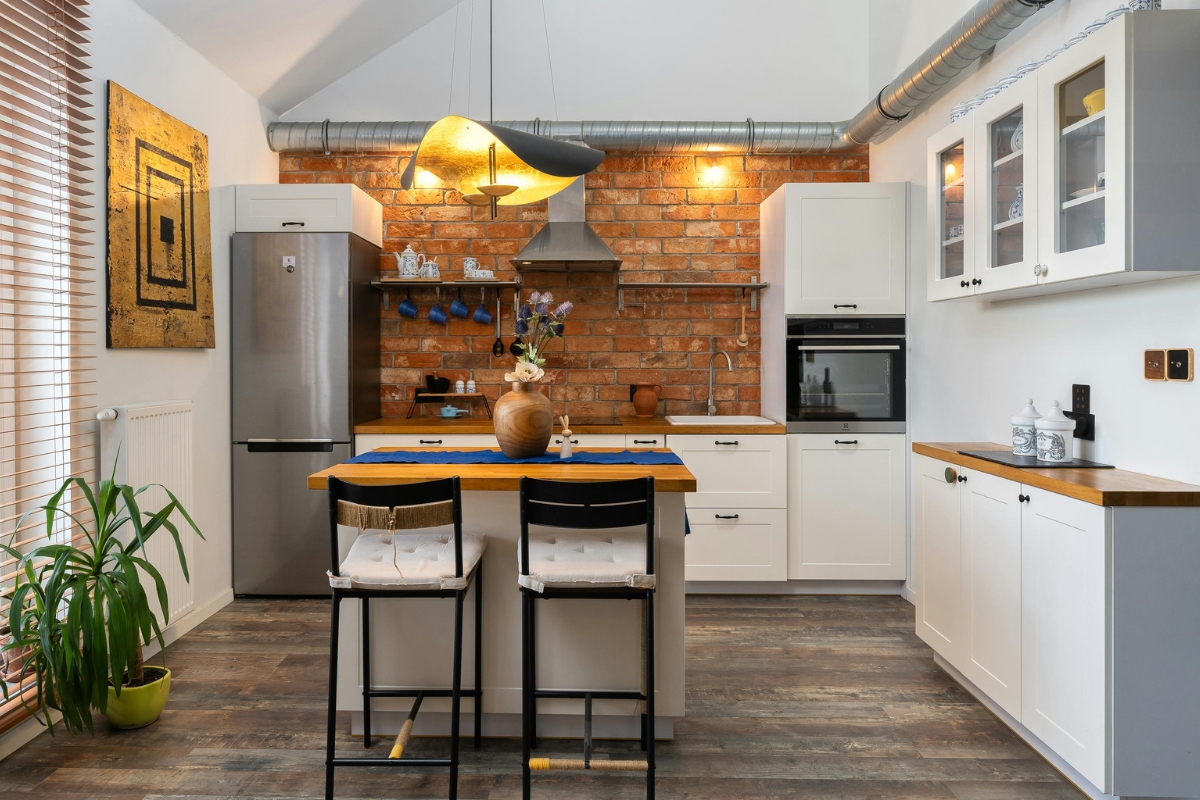 Textured kitchen wall tiles and wooden panels matched with modern kitchen cabinets for a cohesive interior design look