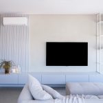 Minimalist living room wall with one large abstract canvas and neutral tones