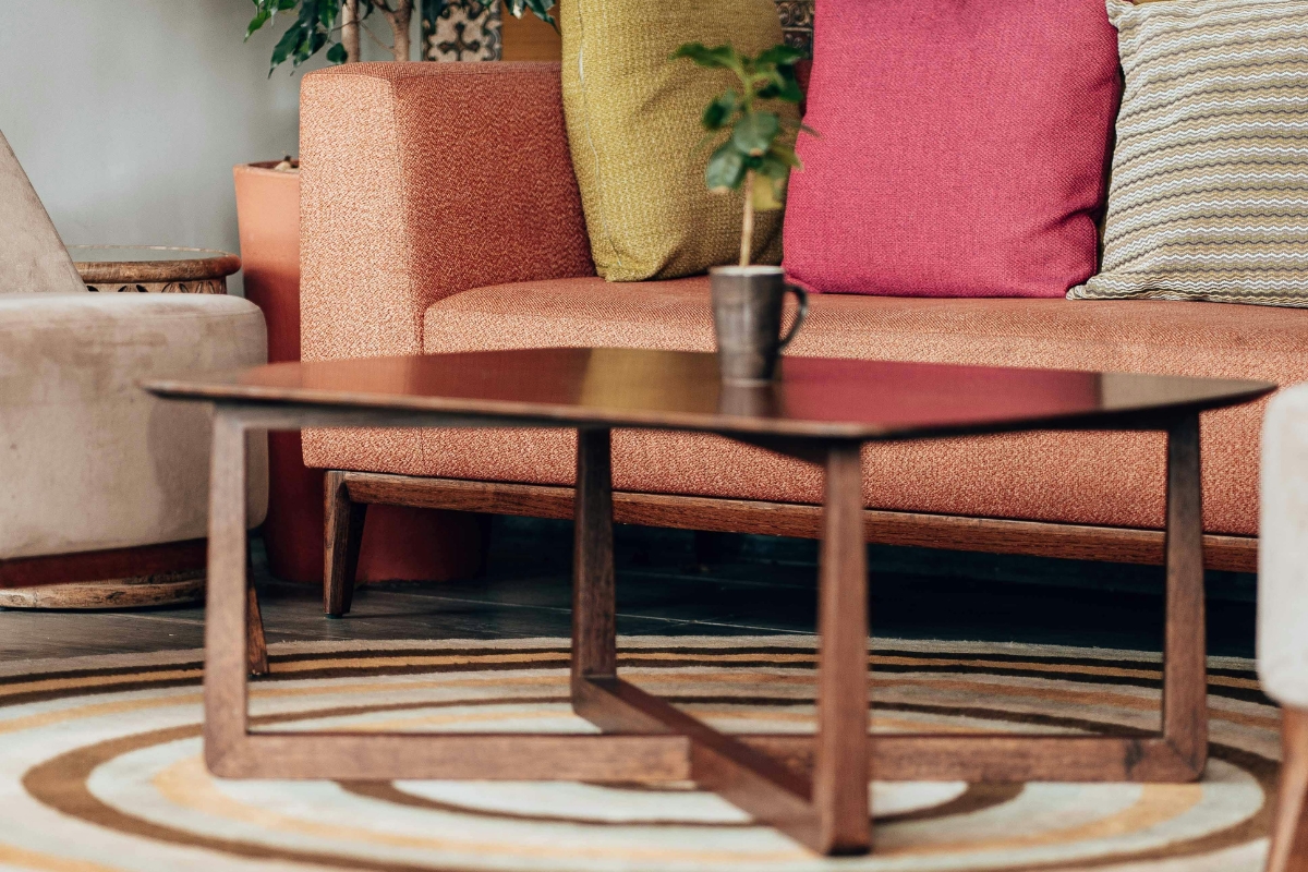 Neutral linen sofa paired with velvet accent chair in living roomWooden dining table with metal chairs for layered textures